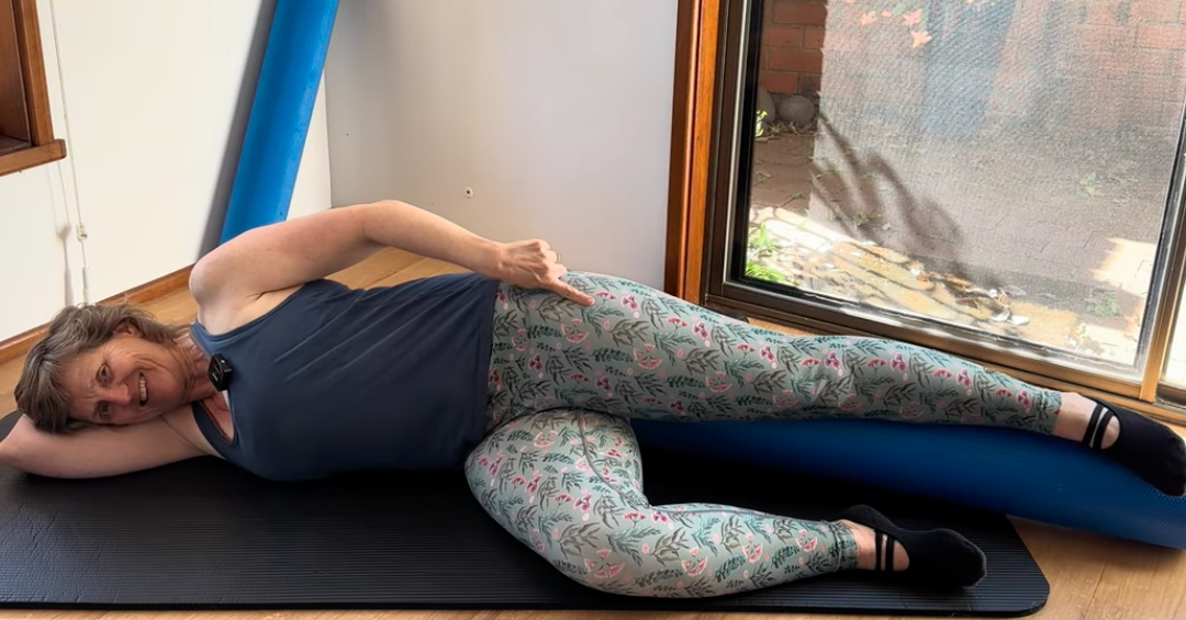 Woman sidelying doing Pilates at home